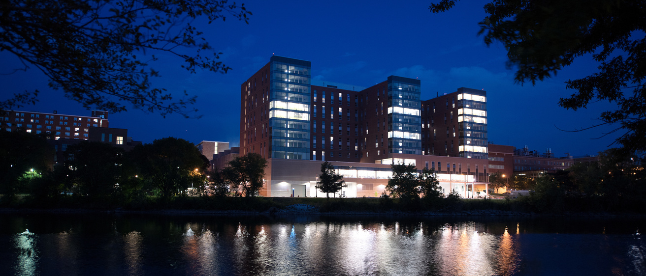 Catlett Residence Hall photographed across the river at night.